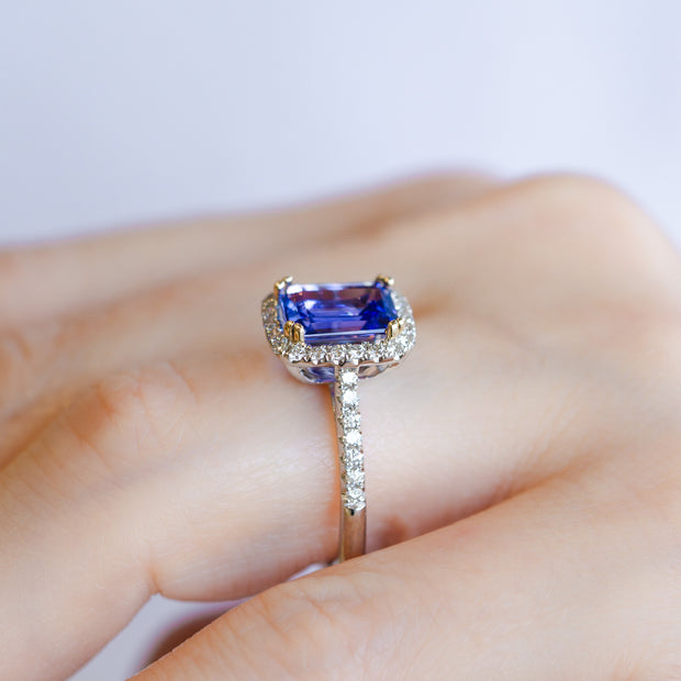 14K White & Yellow Gold 2.36ct Emerald Cut Tanzanite Ring with Diamond Halo & Diamond Accent Band. Bichsel Jewelry in Sedalia, MO. Shop gemstone rings online or in-store!