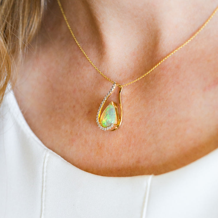 14K Yellow Gold 1.60ct Pear Shape Opal Pendant with Diamond Accents. Bichsel Jewelry in Sedalia, MO. Shop gemstone styles online or in-store today!