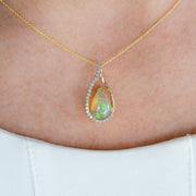 14K Yellow Gold 1.60ct Pear Shape Opal Pendant with Diamond Accents. Bichsel Jewelry in Sedalia, MO. Shop gemstone styles online or in-store today!