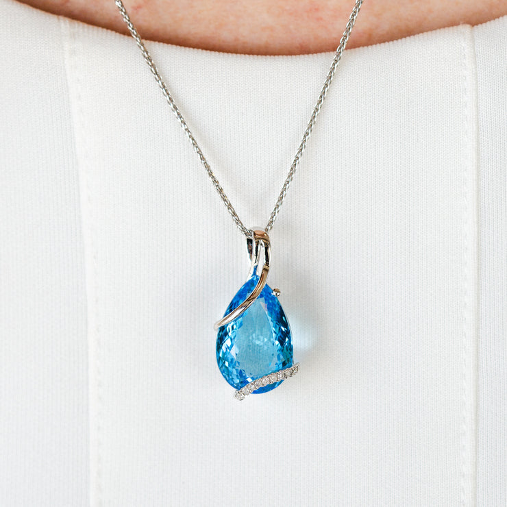 14K White Gold 14.57ct Pear Shape Swiss Blue Topaz Necklace with Swirling Diamond Accents. Bichsel Jewelry in Sedalia, MO. Shop online or in-store today!