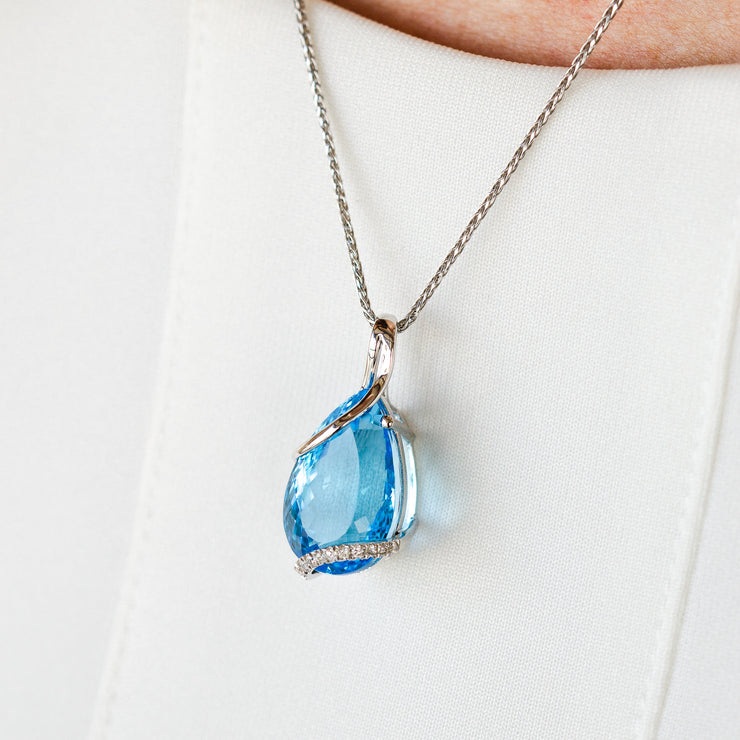 14K White Gold 14.57ct Pear Shape Swiss Blue Topaz Necklace with Swirling Diamond Accents. Bichsel Jewelry in Sedalia, MO. Shop online or in-store today!