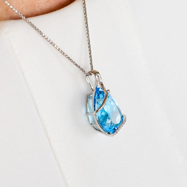 14K White Gold 14.57ct Pear Shape Swiss Blue Topaz Necklace with Swirling Diamond Accents. Bichsel Jewelry in Sedalia, MO. Shop online or in-store today!