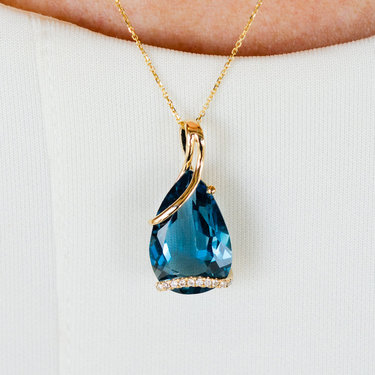 14K Yellow Gold 9.85ct Pear Shape London Blue Topaz Necklace with Swirling Diamond Accents. Bichsel Jewelry in Sedalia, MO. Shop online or in-store today!