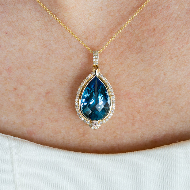 14K Yellow Gold 6.25ct Pear Shape Swiss Blue Topaz Pendant with Diamond Halo. Bichsel Jewelry in Sedalia, MO. Shop gemstone styles online or in-store!