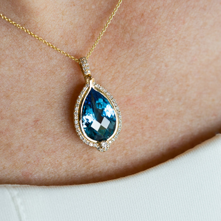 14K Yellow Gold 6.25ct Pear Shape Swiss Blue Topaz Pendant with Diamond Halo. Bichsel Jewelry in Sedalia, MO. Shop gemstone styles online or in-store!