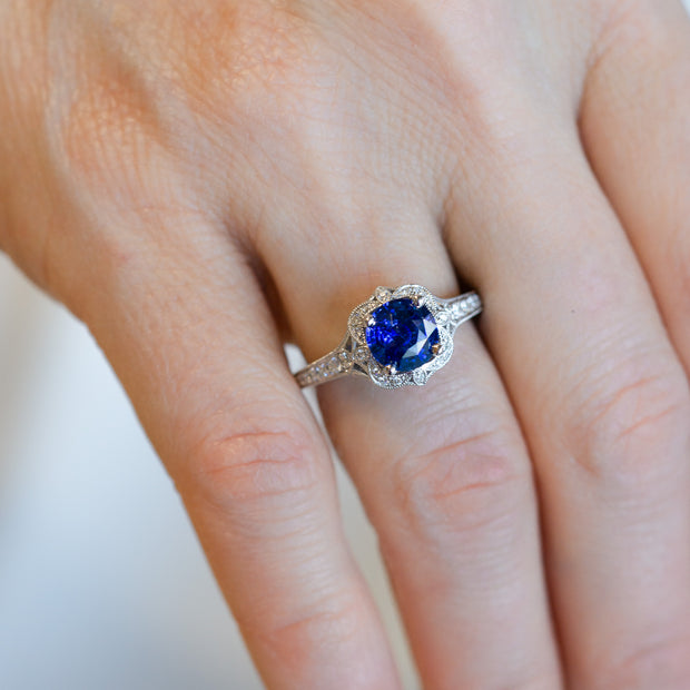 14K White Gold Vintage-Inspired Round 1.82ct Sapphire Ring with Diamond Halo and Band, Milgrain Edge. Bichsel Jewelry in Sedalia, MO. Shop gemstone styles online or in-store!
