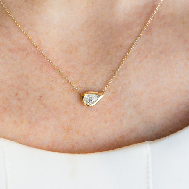 14K Yellow Gold East-West Bezel 0.31ct Pear Shape Diamond Necklace. Bichsel Jewelry in Sedalia, MO. Shop diamond jewelry online or in-store!