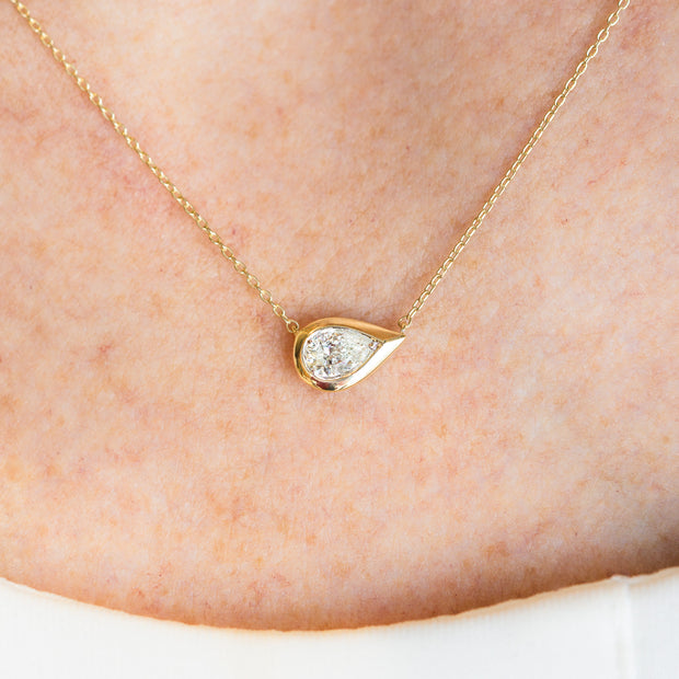 14K Yellow Gold East-West Bezel 0.31ct Pear Shape Diamond Necklace. Bichsel Jewelry in Sedalia, MO. Shop diamond jewelry online or in-store!