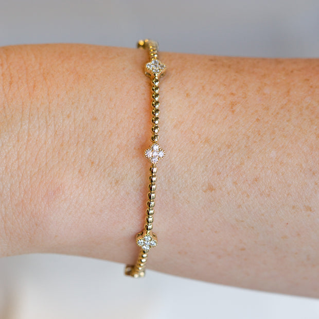 14K Yellow Gold 0.50ct Diamond Clover Beaded Bangle Bracelet. Bichsel Jewelry in Sedalia, MO. Shop gold and diamond jewelry online or in-store!