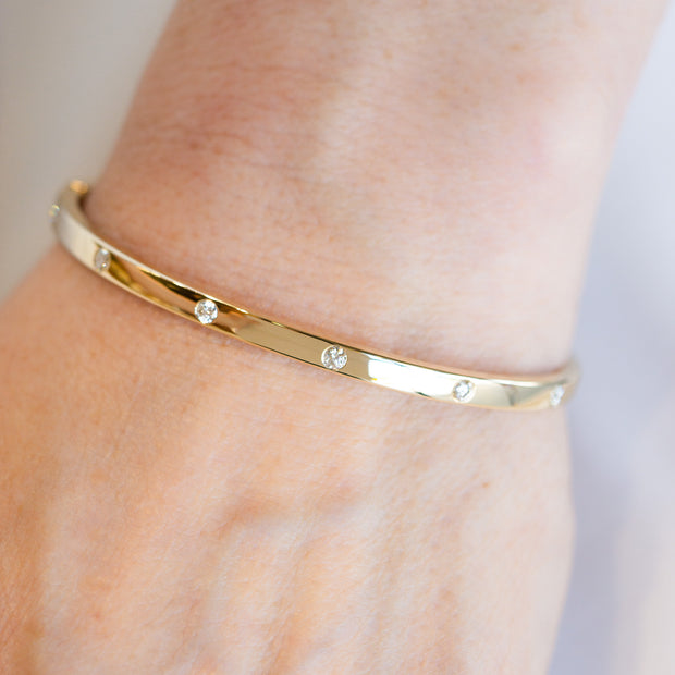 14K Yellow Gold 0.35ct Round Diamond Inlay Bangle Bracelet. Bichsel Jewelry in Sedalia, MO. Shop gold and diamond jewelry online or in-store!