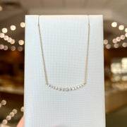 14K Yellow Gold 0.31ct Round Diamond Curved Bar Necklace. Bichsel Jewelry in Sedalia, MO. Shop pendant styles online or in-store today! 
