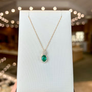 14K Yellow Gold 0.80ct Oval Emerald Pendant with Diamond Halo & Pear Shape Diamond Bail. Bichsel Jewelry in Sedalia, MO. Shop gemstone styles online or in-store! 