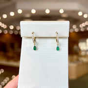 10K Yellow Gold Diamond Huggie Hoop Earrings with Petite Pear Shape Emerald Dangles. Bichsel Jewelry in Sedalia, MO. Shop gemstone hoops online or in-store!