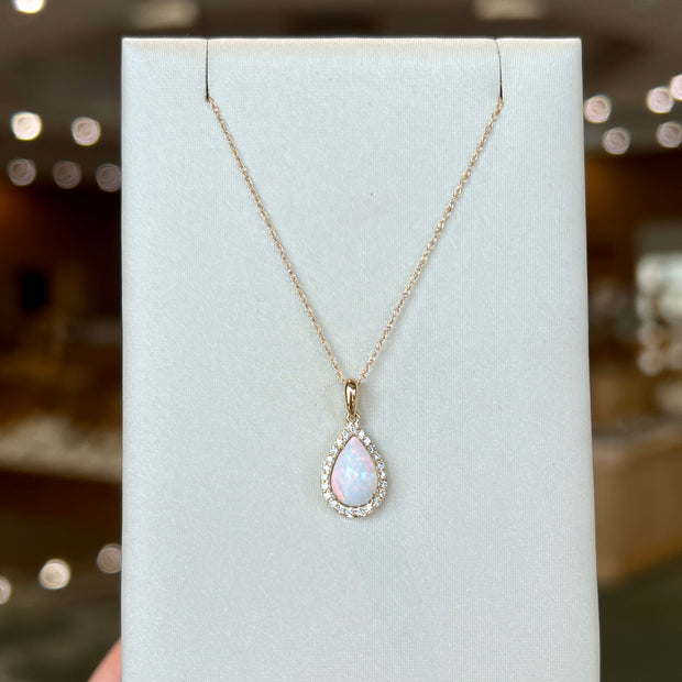 14K Yellow Gold 0.75ct Pear Shape Opal Pendant with Diamond Halo. Bichsel Jewelry in Sedalia, MO. Shop opal gemstone styles online or in-store today! 