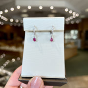 10K White Gold Diamond Huggie Hoop Earrings with Petite Pear Shape Ruby Dangles. Bichsel Jewelry in Sedalia, MO. Shop gemstone hoops online or in-store!