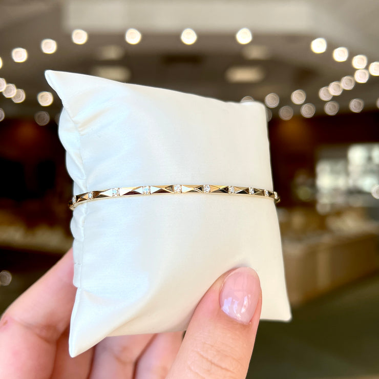 Stackable 14K Yellow Gold Faceted Flexible Bangle Bracelet with 0.20ct Round Diamond Accents. Bichsel Jewelry in Sedalia, MO. Shop online or in-store today!