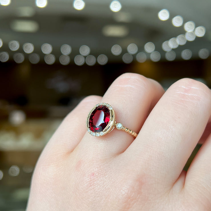 14K Yellow Gold 2.94ct Oval Garnet Ring with Round Diamond Accents, Milgrain Details, & Beaded Band. Bichsel Jewelry in Sedalia, MO. Shop online or in-store today!