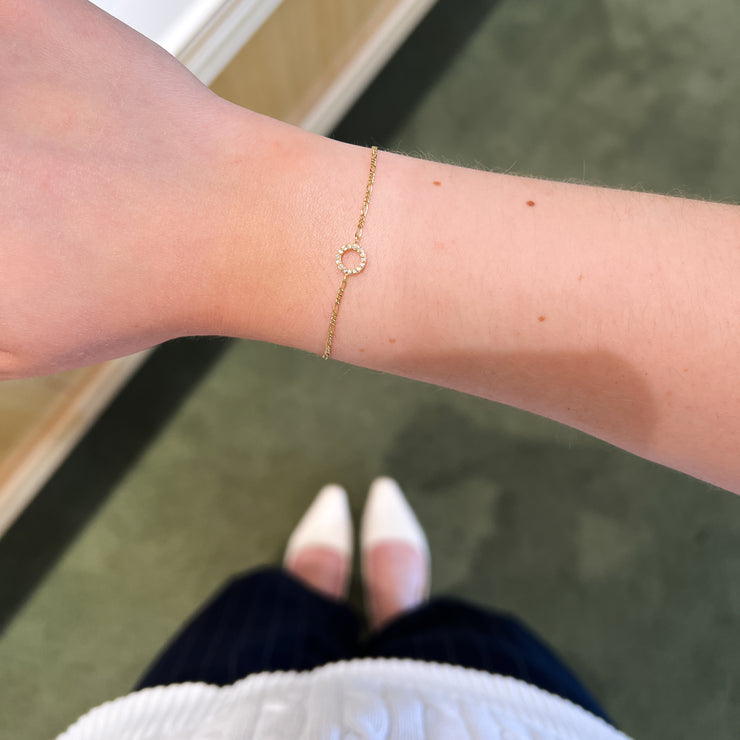 14K Gold Open Circle Diamond Horizontal Charm for Permanent Bracelets. Book your permanent jewelry appointment today to get it welded on to the gold chain of your choice! Bichsel Jewelry in Sedalia, MO.