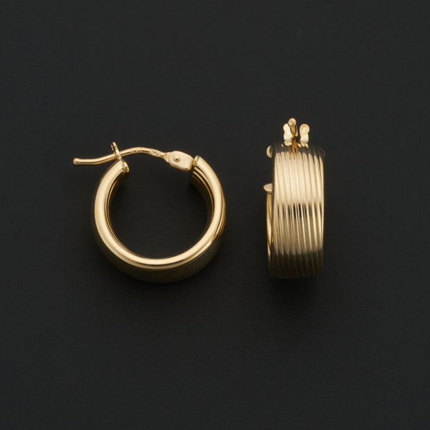 14K Yellow Gold 6x10mm Ribbed Wide Hoop Earrings. Bichsel Jewelry in Sedalia, MO. Shop gold earrings online or in-store today!